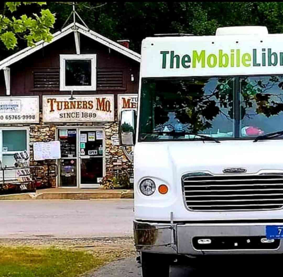 The Bookmobile from the front in front of Turners Station on a sunny day.